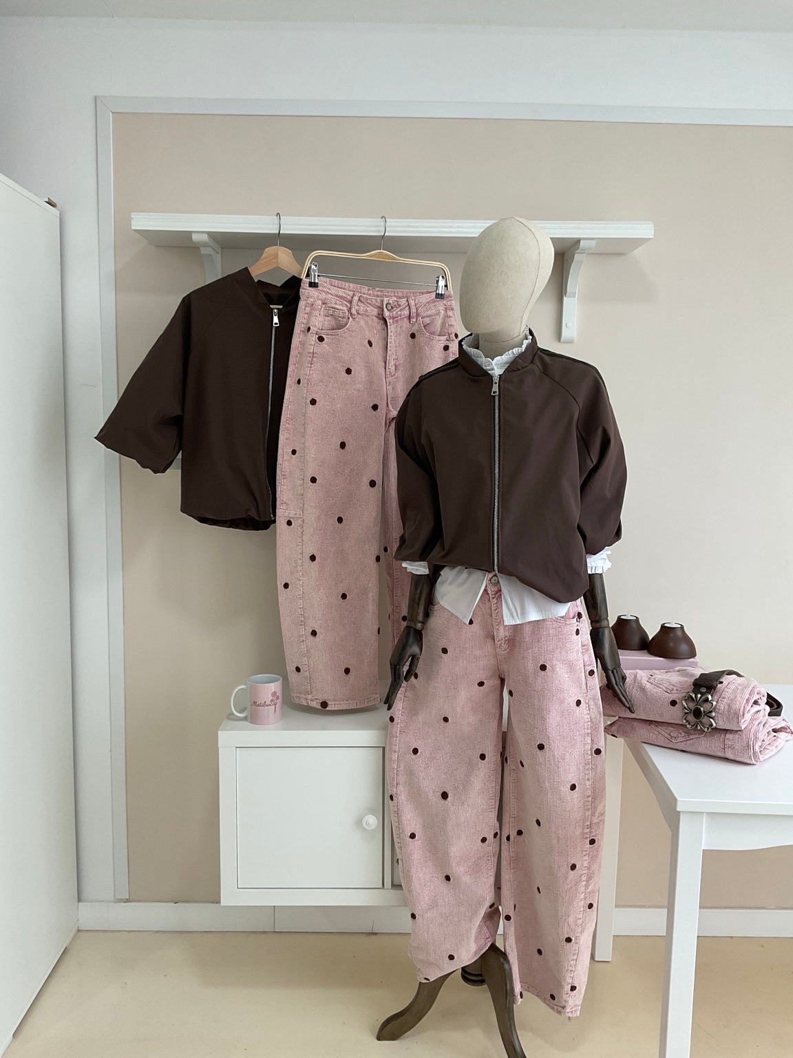 Cazadora bomber marrón con rayas laterales y pantalón rosa de pana con topos