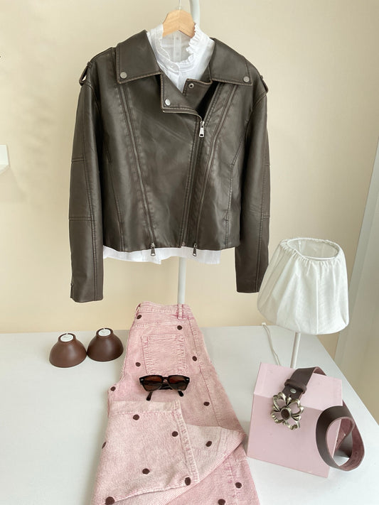 Cazadora biker marrón combinada con pantalón rosa de lunares